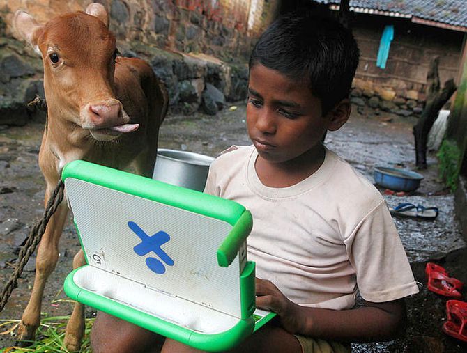 Harish, 11, a school boy uses a laptop provided under the "One Laptop Per Child' project by a non-governmental organisation (NGO).