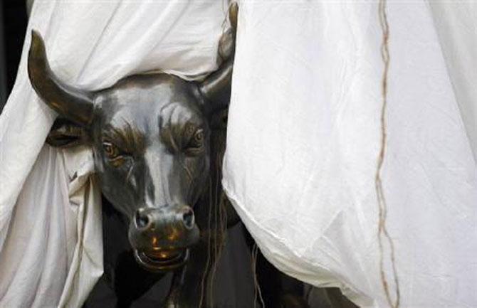 A bronze replica of a bull is seen at the gates of the Bombay Stock Exchange building.