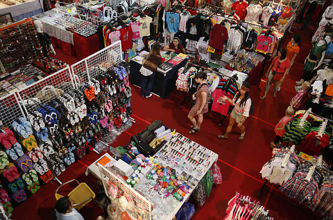 People shop at a shopping mall in Kuala Lumpur, Malaysia.