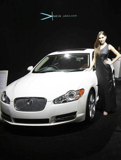 A model poses with a Jaguar XF in New Delhi.