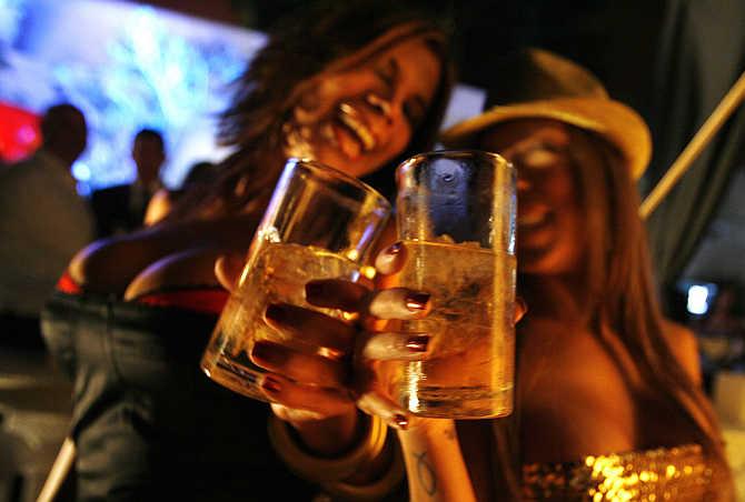 Venezuelan women dance and drink whisky during a Playboy magazine party in Caracas.