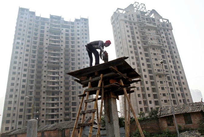 A labourer works at the construction site of a residential complex in Kolkata.