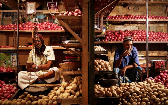 Vendors waits for customers at their stalls at a wholesale food market in Mumbai December 16, 2013.