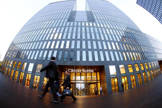 People walk past an office building of Swiss bank Credit Suisse in Zurich.