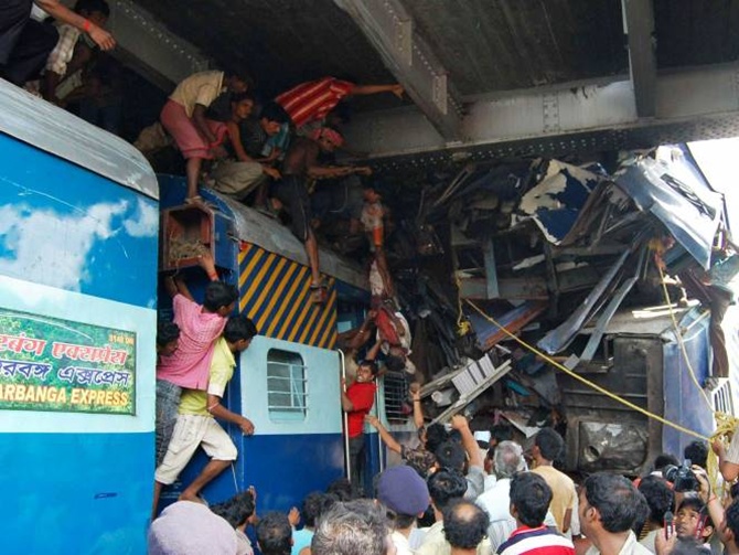 Volunteers conduct rescue operations on the wreckage of train carriages at the site of an accident at Sainthia in West Bengal.
