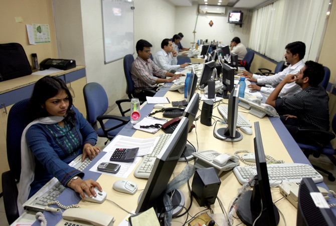 This file photograph shows brokers trading on their computer terminals at a stock brokerage firm in Mumbai.