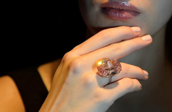 Model Annabeth Murphy-Thomas poses with The Pink Star diamond at Sotheby's auction house in central London October 24, 2013.