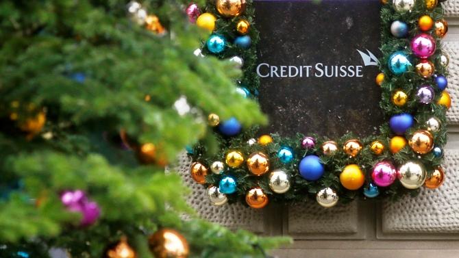 Christmas decoration is placed around the logo of Swiss bank Credit Suisse beside the entrance to its headquarters in Zurich November 21, 2013. 