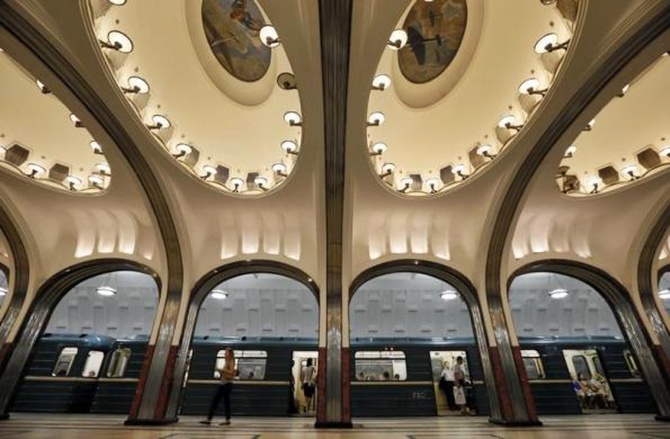A woman walks on the platform as a train arrives at Mayakovskaya metro station, which was built in 1938, in Moscow.