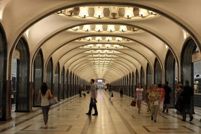 People wait for the train in Mayakovskaya metro station, which was built in 1938, in Moscow