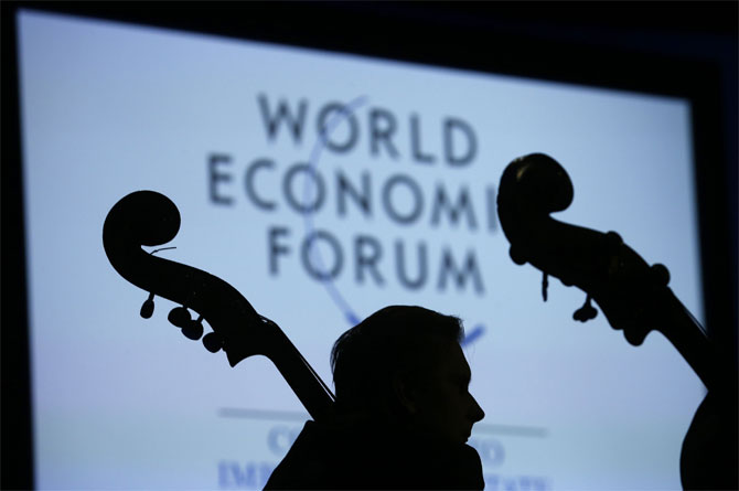 A musician of the St Petersburg Mariinsky Theatre Orchestra is silhouetted as he listens during the Crystal Awards Ceremony at the annual meeting of the World Economic Forum (WEF) 2014 in Davos January 21, 2014.
