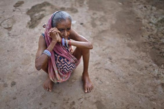 A woman sits on the ground at a transit camp for villagers who have been displaced in Jagatsinghpur district, about 75 km east of Orissa's state capital Bhubaneswar
