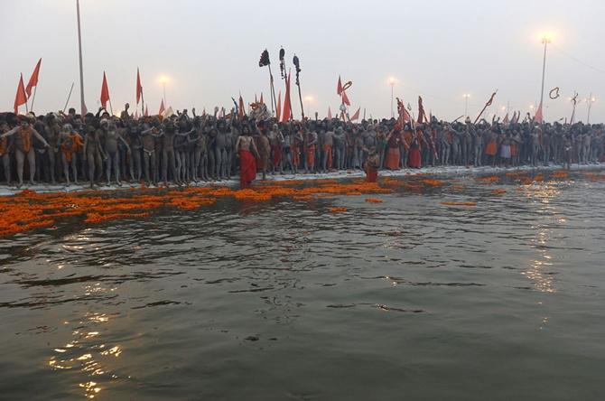 Priests prepare to take a holy dip during first Shahi Snan (grand bath) at the Kumbh Mela in Allahabad.