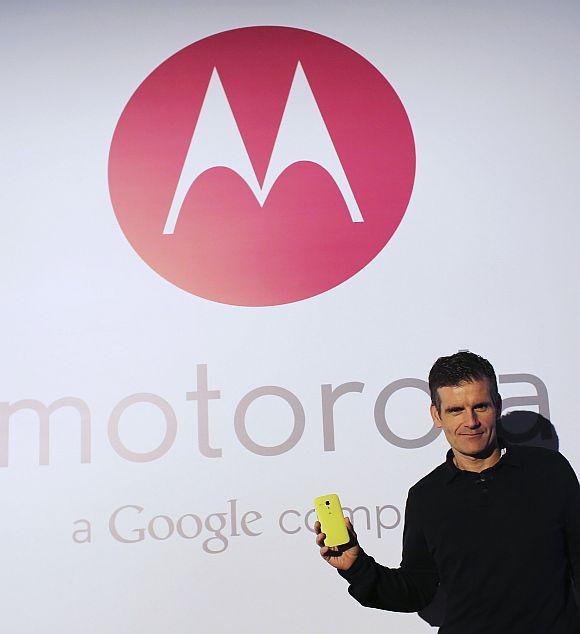 Motorola Mobility Chief Executive Dennis Woodside poses with the new Moto G mobile phone during its worldwide presentation in Sao Paulo.