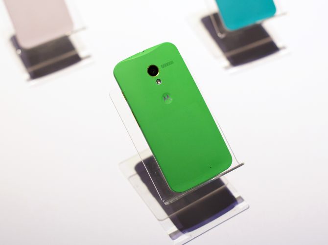 Different colored examples of Motorola's new Moto X phones rest on a table at a launch event in New York.