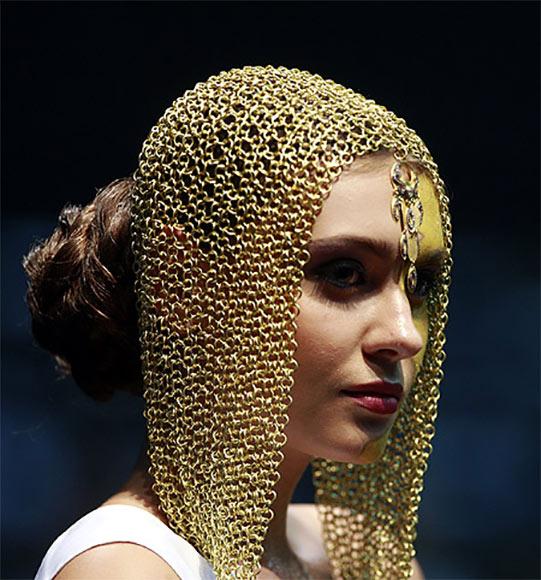 A model displays gold jewellery.