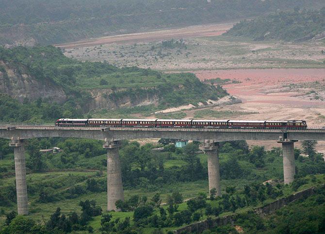 A passenger train coming from Udhampur moves over a bridge in Bazalata on the outskirts of Jammu.