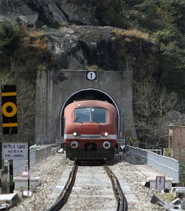 A passenger train travelling the Jammu-Udhampur rail line comes out of a tunnel on the outskirts of Jammu.