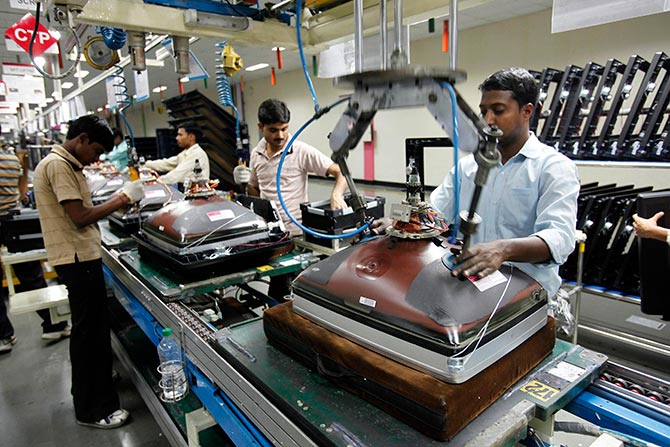 Workers at LG Electronics India Pvt Ltd. assemble television sets inside a factory at Greater Noida in Uttar Pradesh.