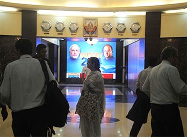  Industrialists watch the live screening of the Union budget 2014-15 speech at Taj Hotel in Colabua on Thursday. The screening was organised by the CII.