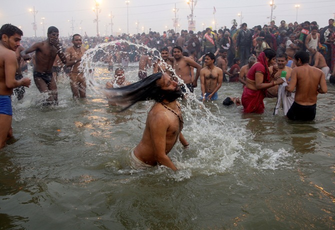 Hindu devotees take dip during the first grand bath at the Kumbh Mela in Allahabad, January 14, 2013.