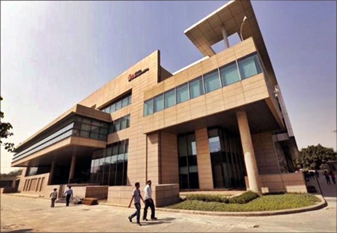 Employees walk inside Tech Mahindra office premises in Noida on the outskirts of New Delhi. 