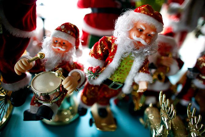 Plastic Santa Claus toys are seen at Christmas shop.