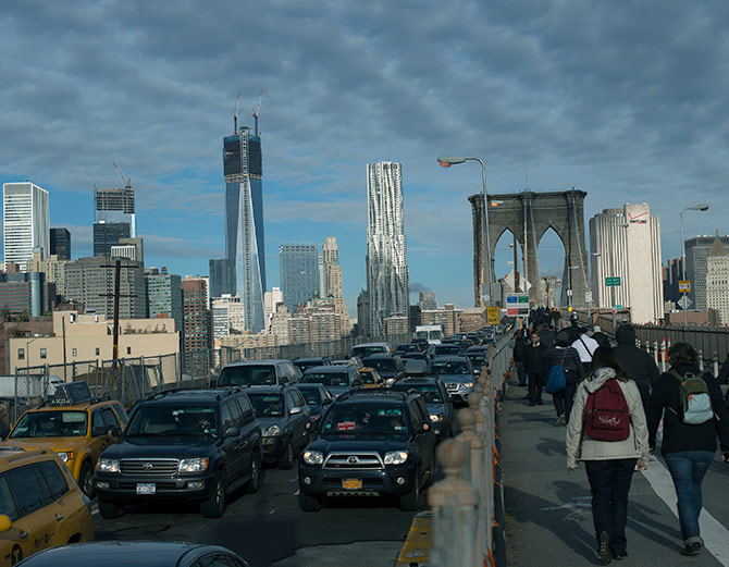 Commuters make their way across the Brooklyn Bridge in New York.