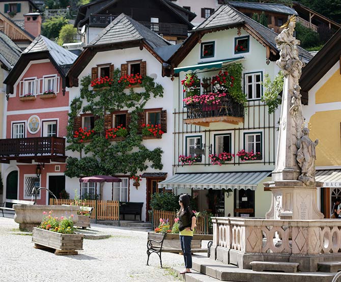Tourists photograph each other in the Austrian world heritage village of Hallstatt.
