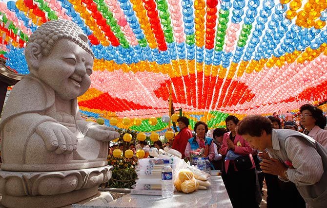 Buddhists pray in front of a statue of Buddha during a prayer meeting to celebrate the birth anniversary of Lord Buddha at the Jogye temple in Seoul.