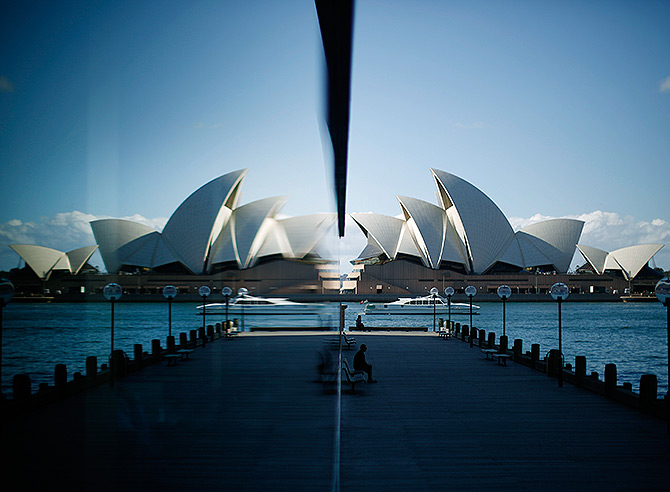 The Sydney Opera House is reflected in a harbourside hotel window in The Rocks district of Sydney.