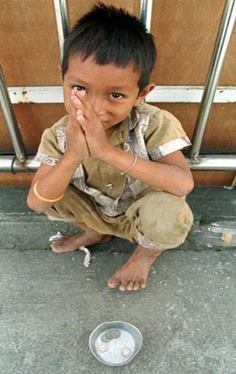 A nine-year-old boy begs for money.