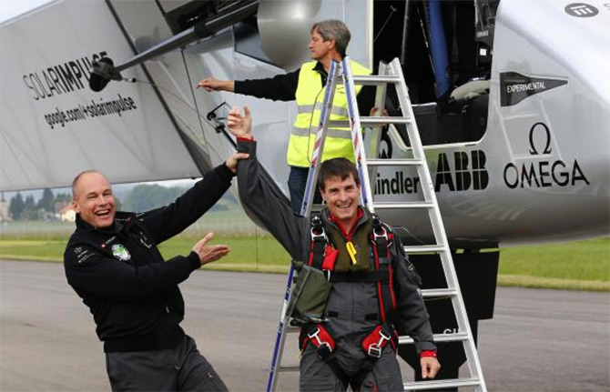 Solar Impulse co-founder Bertrand Piccard (L) congratulates German test pilot Markus Scherdel (R) after steering the solar-powered Solar Impulse 2 aircraft on its maiden flight at its base in Payerne.