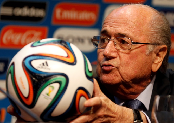 FIFA President Sepp Blatter holds an official 2014 FIFA World Cup soccer ball during a media conference in Sao Paulo June 5, 2014.