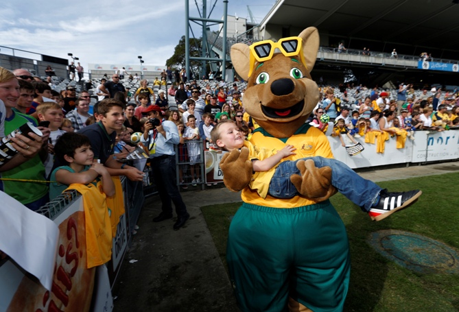 Maloo, the new mascot of Australia's Socceroos national soccer team, carries a soccer fan during a training session of the Socceroos team in Gosford, May 18, 2014.