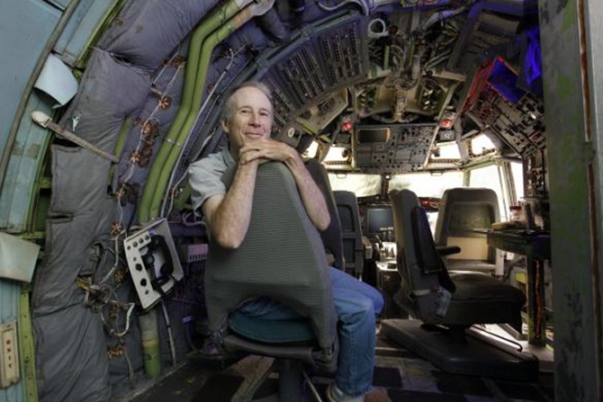 Bruce Campbell sits in the cockpit of his Boeing 727 home.