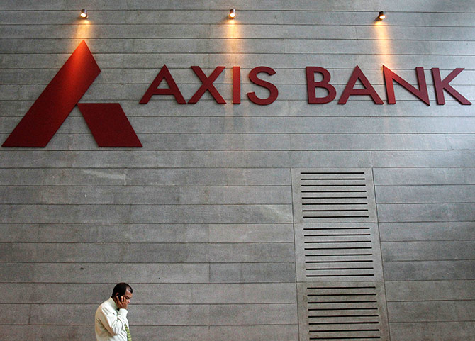 An employee speaks on his mobile phone as he walks inside Axis Bank's corporate headquarters.