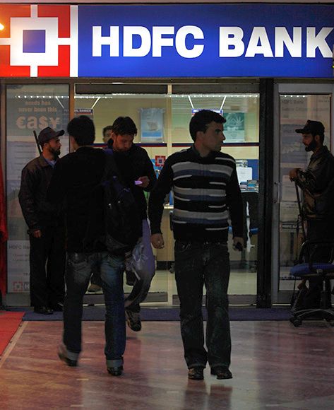 People walk in and out of a HDFC bank branch in Srinagar.