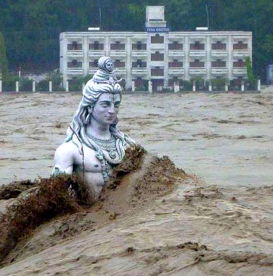 A submerged statue of Lord Shiva stands amid the flooded waters of river Ganges at Rishikesh.