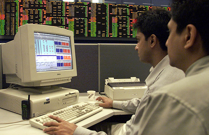 Sri Lankan stock brokers monitor a computer screen during trading at the Colombo Stock Exchange.