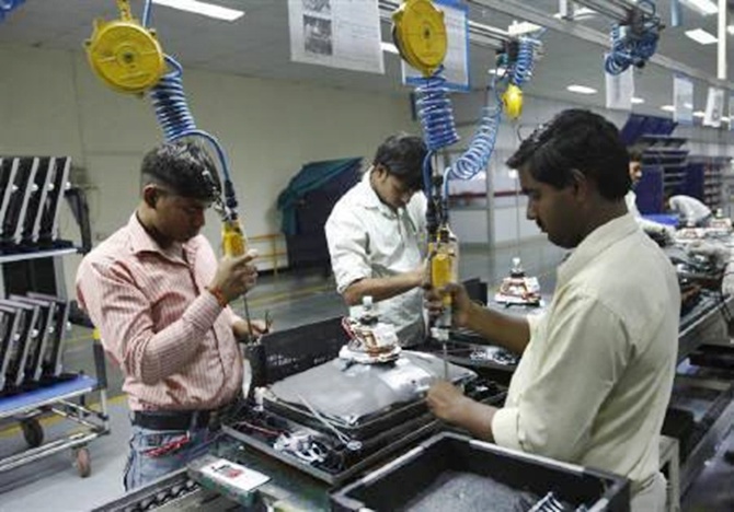 Workers at LG Electronics India Pvt Ltd. assemble television sets inside a factory at Greater Noida in Uttar Pradesh.