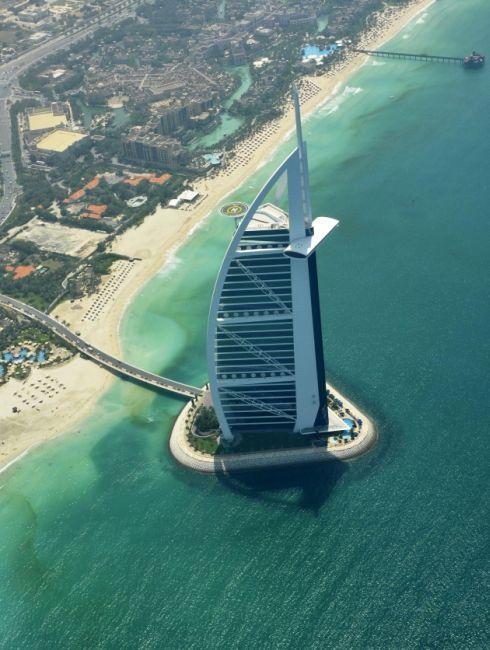 An aerial image with the Burj Al Arab in the foreground, shows the approaching red tide, on the shores of Dubai.