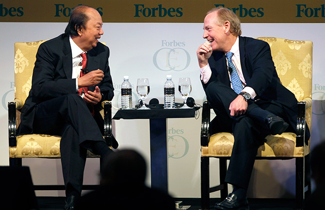 Dr. Tahir (L), Chairman and CEO of Indonesia's Mayapada Group, talks with Alan Quasha, Chairman and CEO of the U.S. Quadrant Management, during Forbes Global CEO Conference.