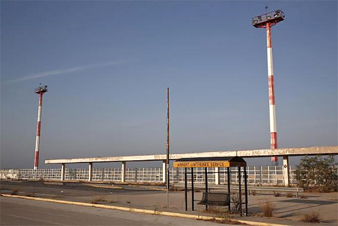 A limousine service stand is seen outside the east terminal of Hellenikon.