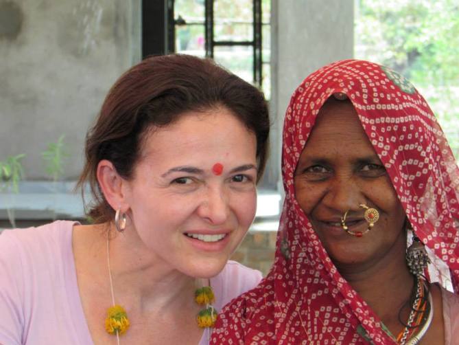 Facebook COO Sheryl Sandberg (left) with a village woman at Kalthana Village, Rajasthan.