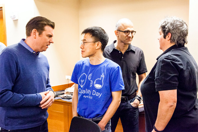 Senior leaders Tony Bates (left), Qi Lu, Satya Nadella and Lisa Brummel backstage, preparing for the One Microsoft Town Hall event in July.