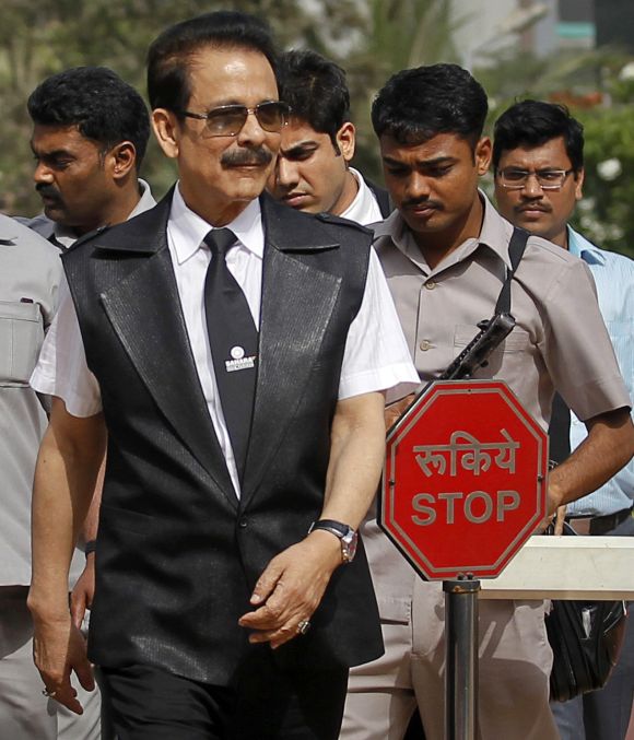Sahara Group Chairman Subrata Roy accompanied by his security leaves the Securities and Exchange Board of India (SEBI) headquarters in Mumbai.