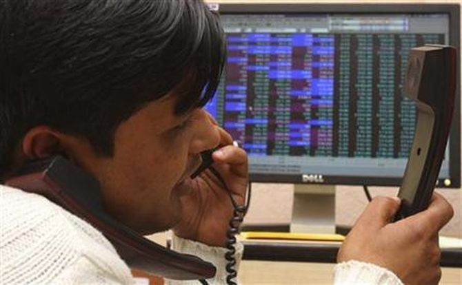 A terminal operator speaks on telephones at a local stock market