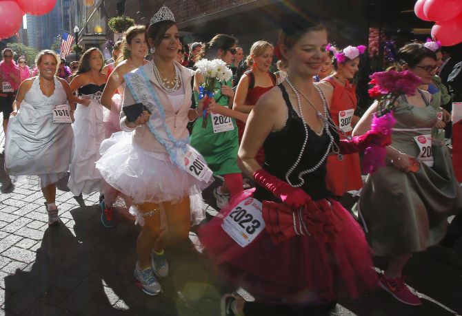Participants leave the starting line at the annual Running with The Bridesmaids event in Boston.