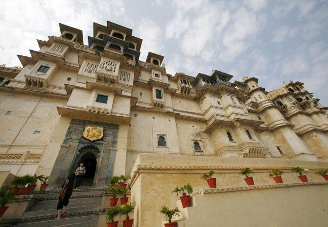 Tourists stand at the City Palace in Udaipur.